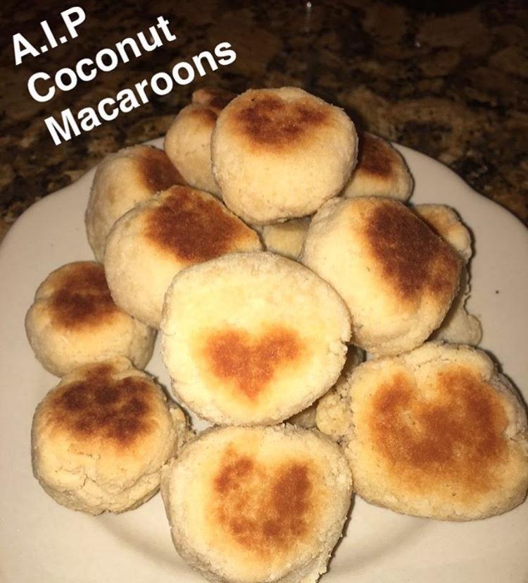 yellow coconut macaroons sitting on a white plate.