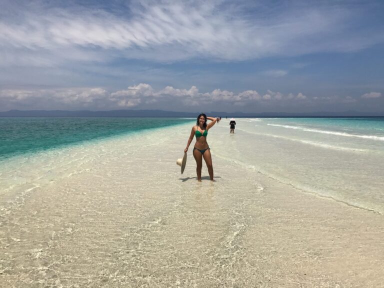 girl in bikini standing on beach in philippines