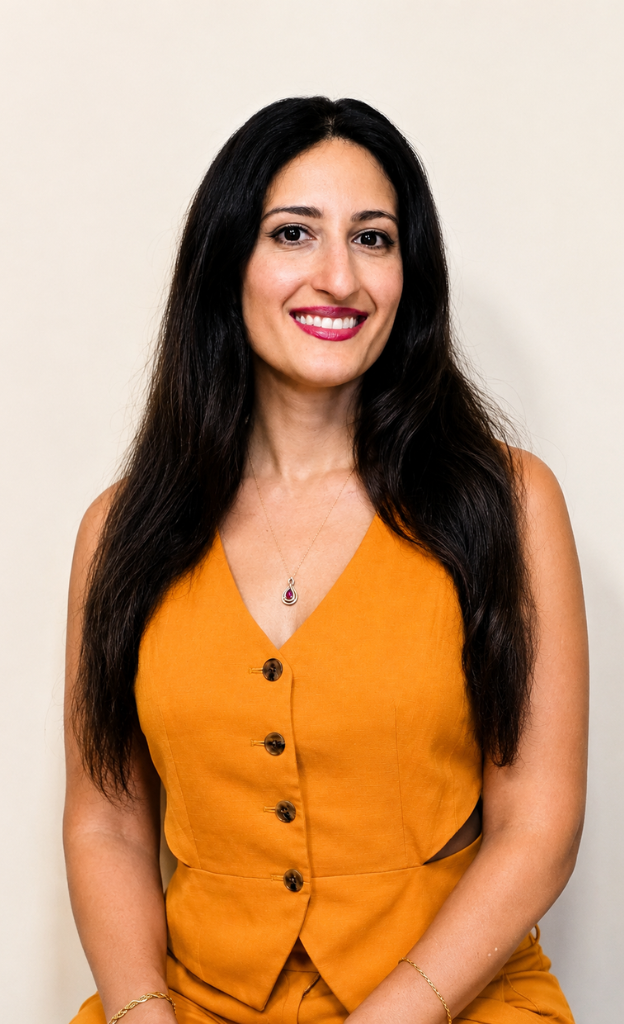 Professional headshot of Dr. Melissa smiling while wearing a mustard-yellow sleeveless top, representing Mind Body Harmony Medicine's integrative and functional medicine practice.