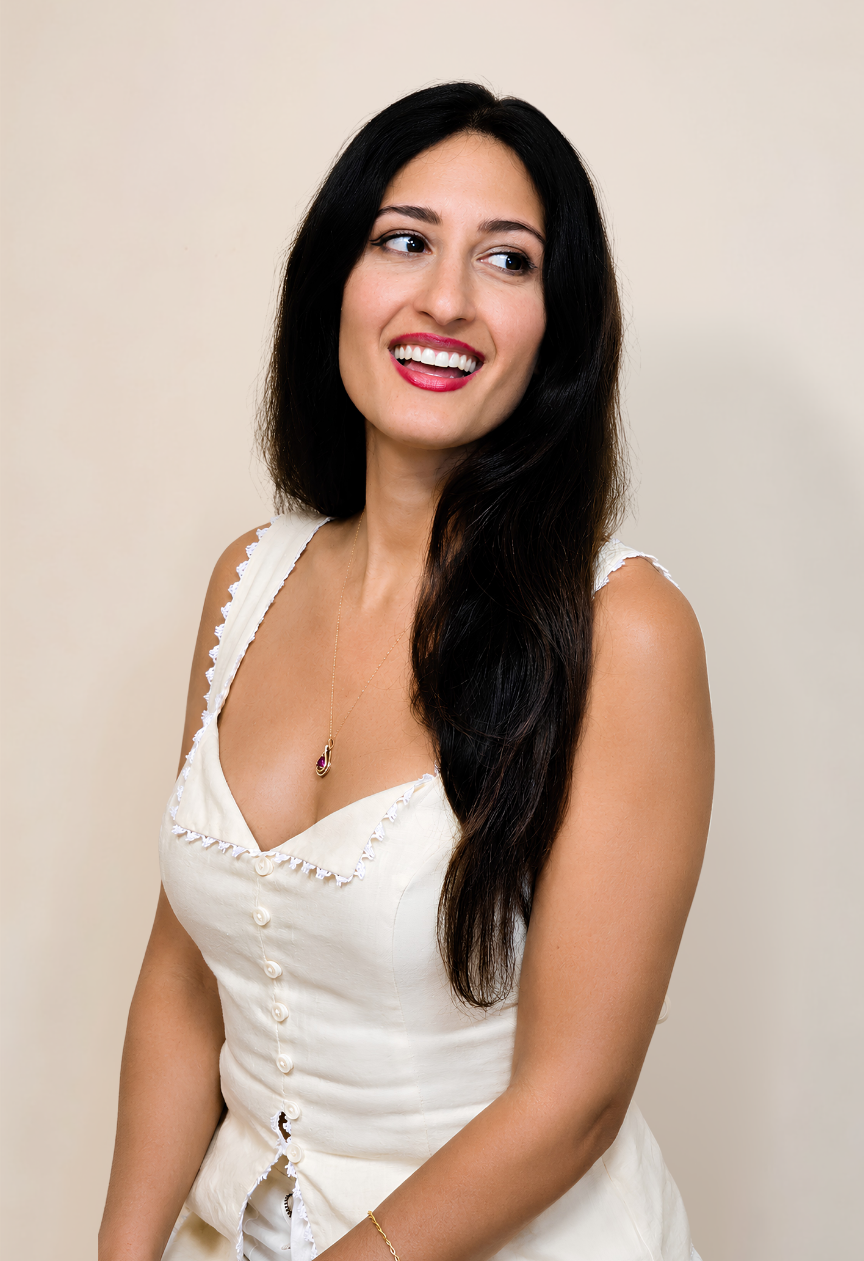 Professional portrait of Dr. Melissa, founder of Mind Body Harmony Medicine, smiling in a white sleeveless top against a neutral background.