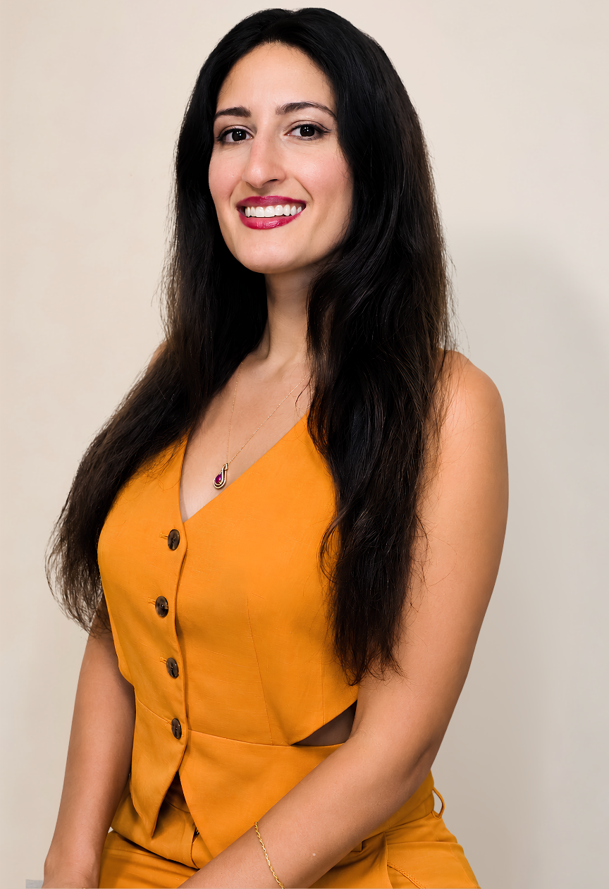 Professional portrait of Dr. Melissa, founder, Mind Body Harmony medicine, smiling while wearing a mustard-yellow sleeveless top against a neutral background.